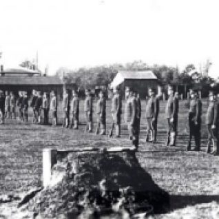 T.L. Kennedy used the Cooksville Fair Grounds as a training ground for his recruits. In this 1914 photo they are engaged in a bayonet exercise.