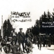 For two weeks in the summer of 1915, the women of Clarkson led by the Women's Institute provided a luncheon for soldiers marching from military training in Niagara to the train in Toronto and embarkation for Europe. Here the men pose for a postcard under the patriotic banner "For Home and Country."